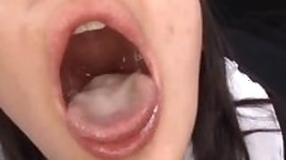 Japanese girl in uniform swallows cum in threesome
