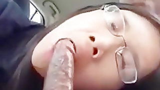 Cute nerdy asian american girl sucks off her black bf in his car