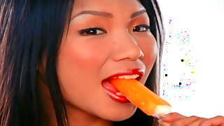 Asian babe is eating ice cream before masturbating