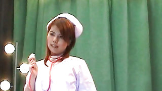 Redhead and sexy nurse in white uniform is posing her sexy ass