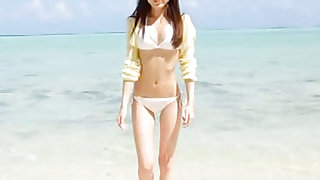 Charming and killing asian lady in bikini is walking outdoors