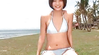 Short haired and playful teen is posing her figure outdoors